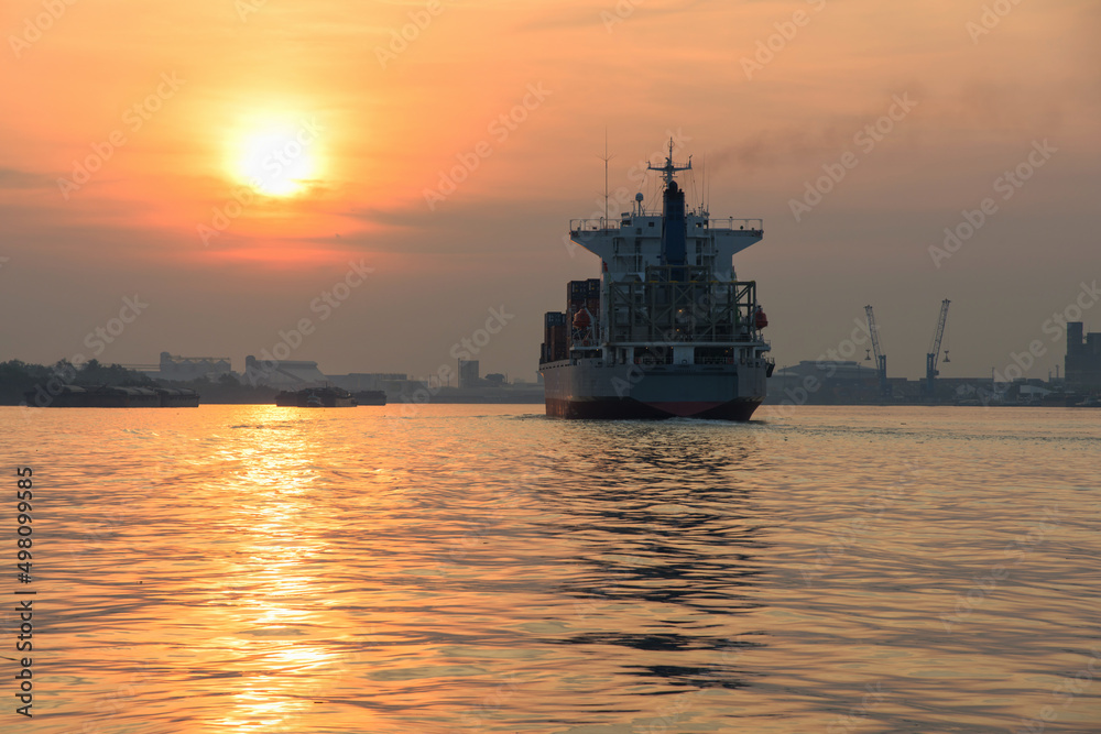 container cargo ship sail over Chao Phraya river at sunrise in Bangkok