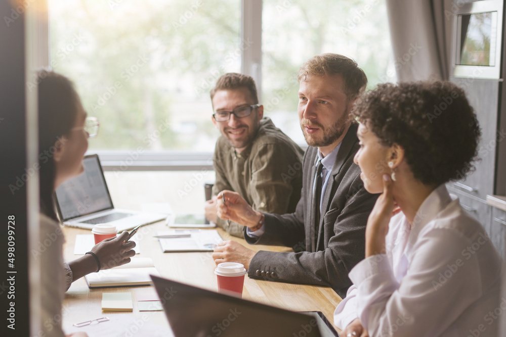 group of business people sitting in a meeting room of a coworkin group of business people sitting in a meeting room of a coworkin