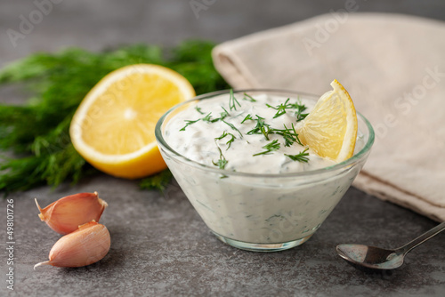 Sour cream sauce with dill and garlic in a bowl on the table. Organic food
