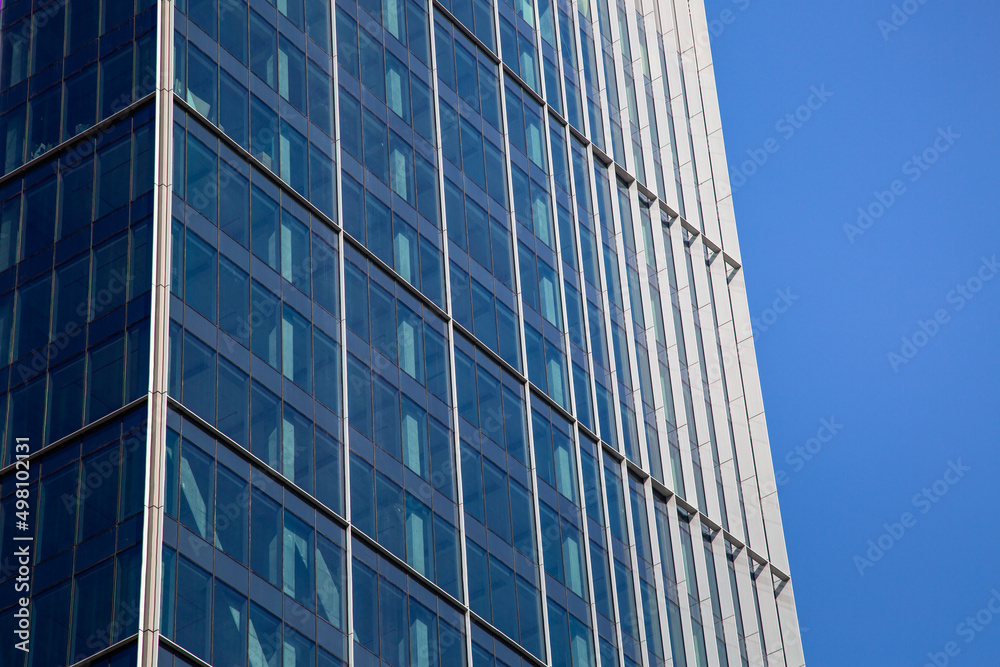 Skyscraper. Skyscraper against the blue sky. Glass and metal building, office and business center in a large city.