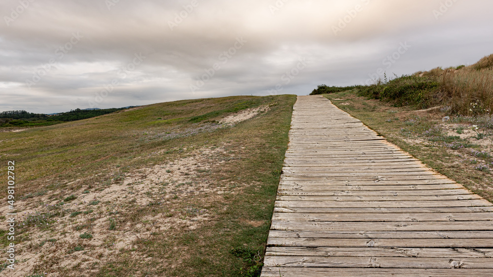Road and nature. It is about wooden pavement, floor, passage, path, path or passageway with nature to walk and connect with the beach in the sea