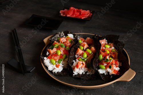 Trendy Hybrid Food Sushi Tacos with salmon, rice and edamame beans.