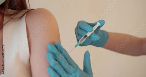 Girl in a mask getting injection on beige background