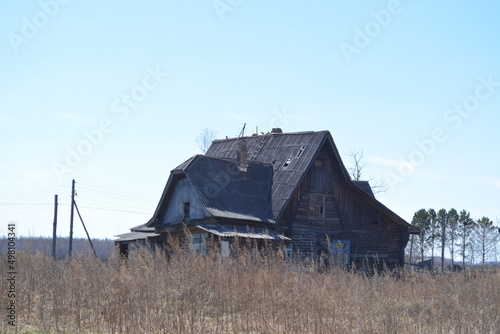Old wooden two-storey apartment building in the village of Bolon , Khabarovsk Krai photo
