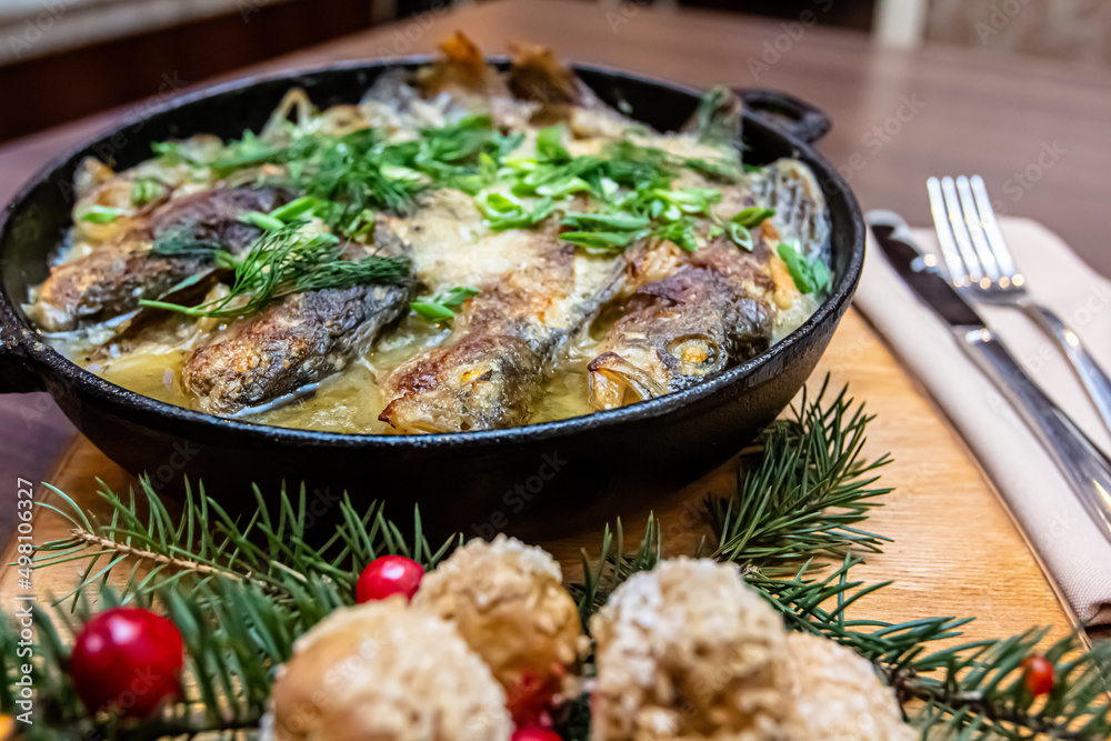 Fish baked in sour cream in a frying pan