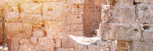 ruined construction of the old stone building. explore the ancient excavations of the ruins of the ancient Lycian city of Phaselis in Turkey in summer nature in the mountains outdoor. banner. flare