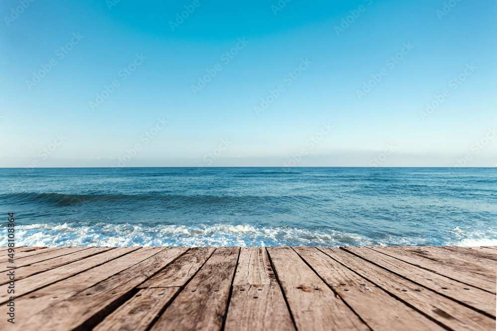 Old boards, floor against the background of the blue sea and sky. The concept of vacation, travel, vacation, wallpaper. Old boards, floor against the background of the blue sea and sky. The concept of vacation, travel, vacation, wallpaper.
