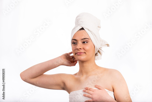 Portrait of beautiful teenage girl. Beautiful girl is arranging the towel on her head.