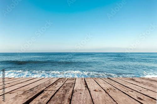 Old boards  floor against the background of the blue sea and sky. The concept of vacation  travel  vacation  wallpaper.