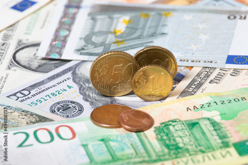 Russian rubles lie with dollars and euros. Financial concept. Macrophotography of currencies. Euro Coins Russian rubles lie with dollars and euros. Financial concept. Macrophotography of currencies. Euro Coins