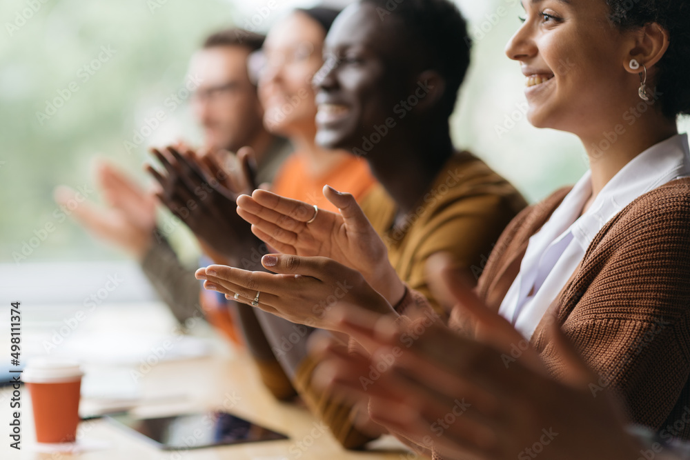 group of diverse business people applauding together.