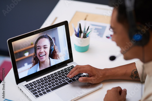 Close up of video screen with a conference call between two young people at work photo