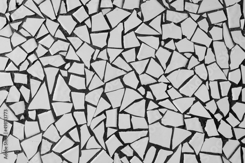 Broken white ceramic tiles mosaic. Abstract. Background. Texture.