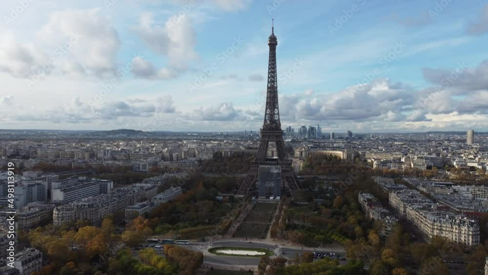 Filming from Tour Eiffe drone against a blue sky with clouds.