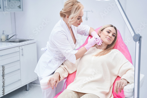 Female patient getting cheek dermal filler injection