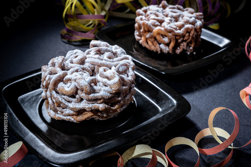 Traditional Finnish cuisine: Funnel cakes with powdered sugar topping are eaten around May 1st with homemade Sima (mead)