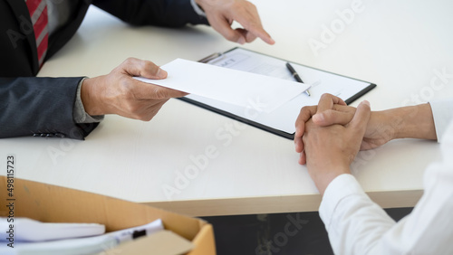 Sad dismissed businessman sitting outside the office after losing his job