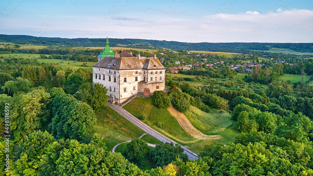 Medieval Olesko Palace aerial view. Green spring trees. Summer park on hills.