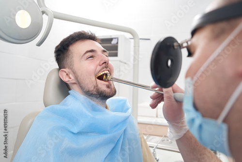 Jolly man during procedures with throat in clinic photo