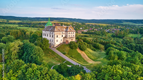 Medieval Olesko Palace aerial view. Green spring trees. Summer park on hills.