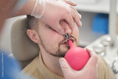 Man patient having nose treated in clinic photo