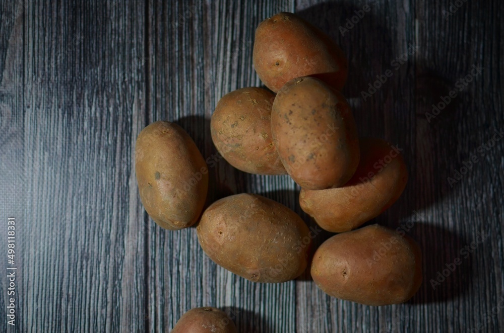 Potatoes on the grey wooden table