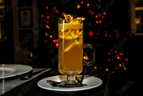 Orange grog in a tall glass stands on the bar photo