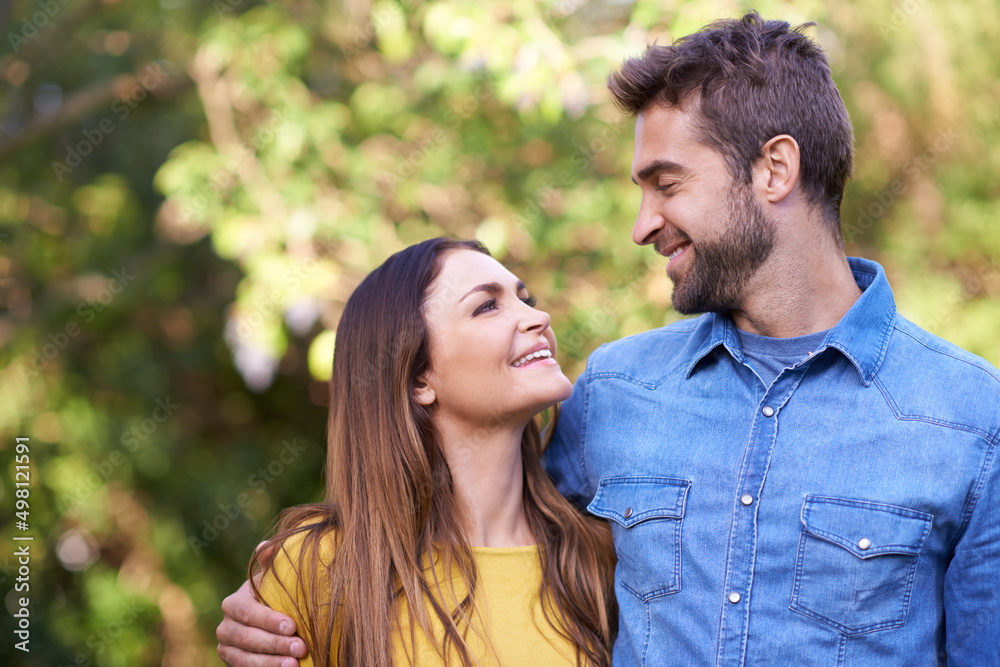 They adore each other. Shot of a happy young couple spending time together outside.