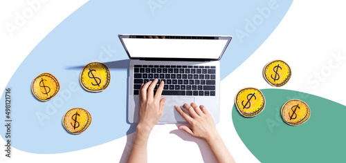 Person using a laptop computer with coins - earn online - work from home themes