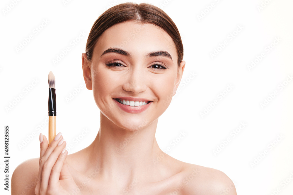 young beautiful woman with make-up brush for powder young beautiful woman with make-up brush for powder