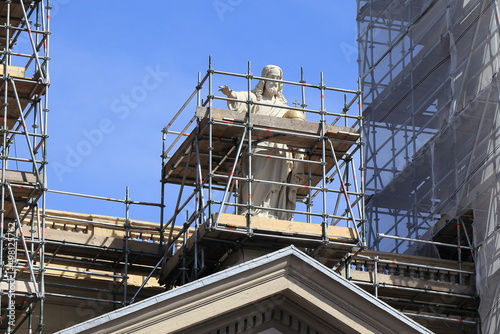 Amsterdam Mozes en Aaronkerk Church Exterior Detail with Statue of Christ and Renovation Scaffolding, Netherlands