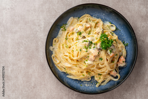 homemade fettuccine pasta with white cream sauce. fettuccine Carbonara made with eggs, hard cheese, cured pork, and black pepper. Italian food.
