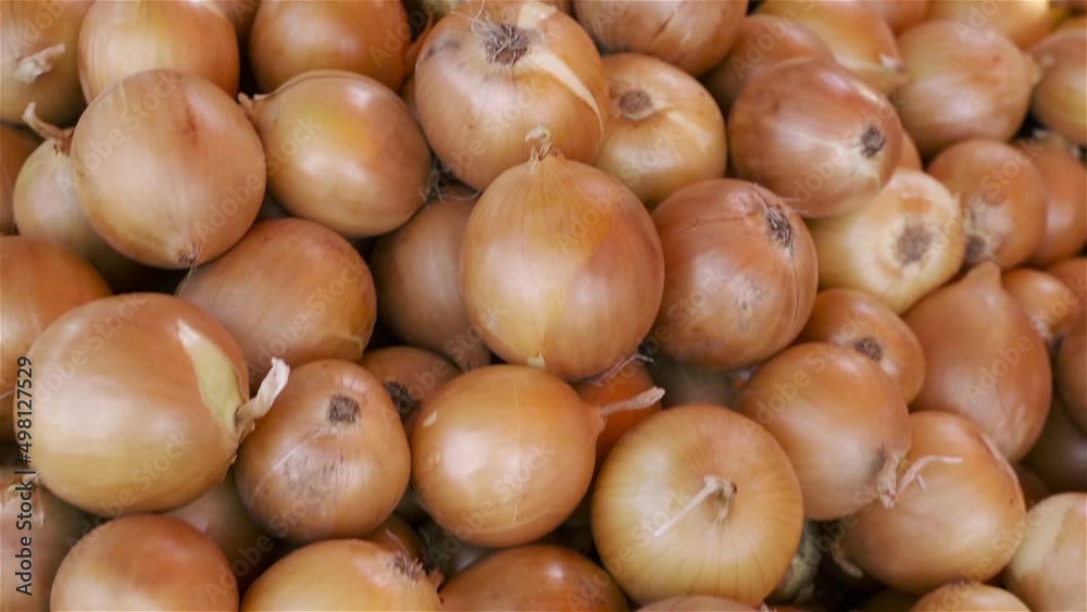 Background of ripe yellow onions. New harvest, texture. Street vegetable market. Background of ripe yellow onions. New harvest, texture. Street vegetable market.