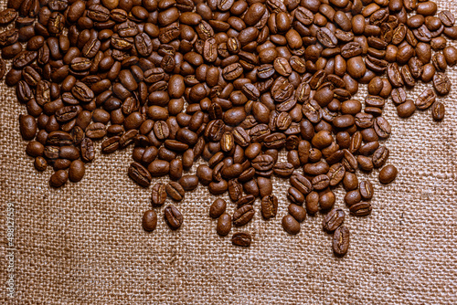 Roasted coffee beans with burlap background