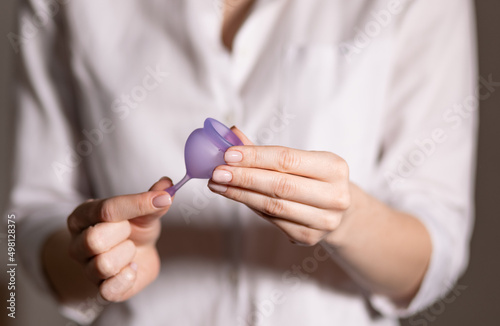 menstrual cup in the hands of a woman