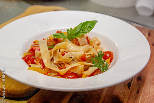 Pappardelle or Linguini pasta in tomato sauce lies on a plate