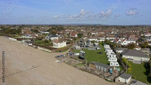 East Preston seafront village in West Sussex with the Camping site in view next to a cafe. Aerial  photo