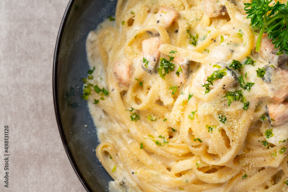 homemade fettuccine pasta with white cream sauce. fettuccine Carbonara made with eggs, hard cheese, cured pork, and black pepper. Italian food. homemade fettuccine pasta with white cream sauce. fettuccine Carbonara made with eggs, hard cheese, cured pork, and black pepper. Italian food.