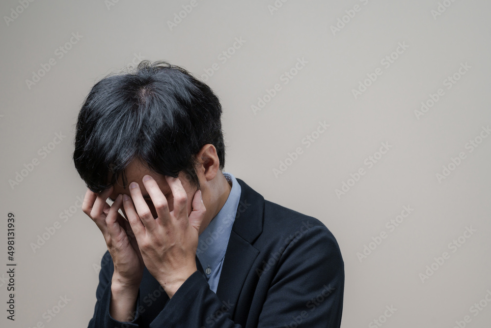Young troubled businessman sad and holding his head in despair and depress lonely, depression concept Young troubled businessman sad and holding his head in despair and depress lonely, depression concept