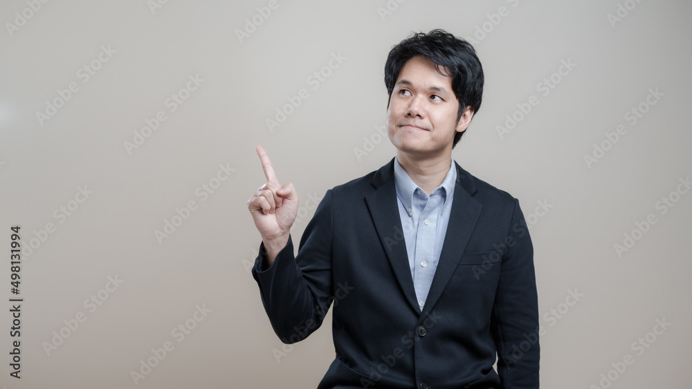 Surprised and impressed, Asian business man entrepreneur office manager pointing upper corner space and look amazed,Smart casual man success, finance and people concept. Surprised and impressed, Asian business man entrepreneur office manager pointing upper corner space and look amazed,Smart casual man success, finance and people concept.