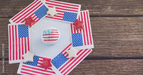 Close up view of american flag design cookies on wooden surface with copy space