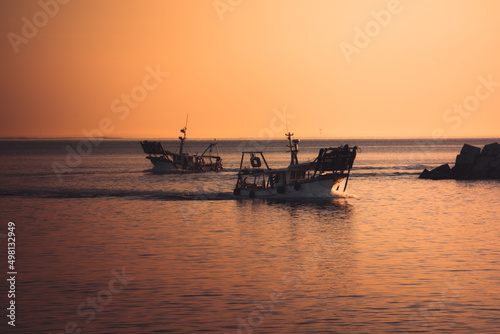 san benedetto del tronto, pescherecci escono in mare dal molo del portoper la pesca all'alba photo