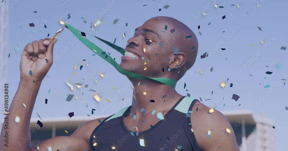 Animation of confetti over happy african american sportsman kissing medal and enjoying victory
