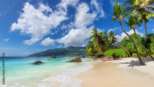 Fototapeta Naklejka Na Ścianę i Meble -  Exotic tropical Sunny beach and coconut palm trees on Seychelles island. Summer vacation and tropical beach concept.