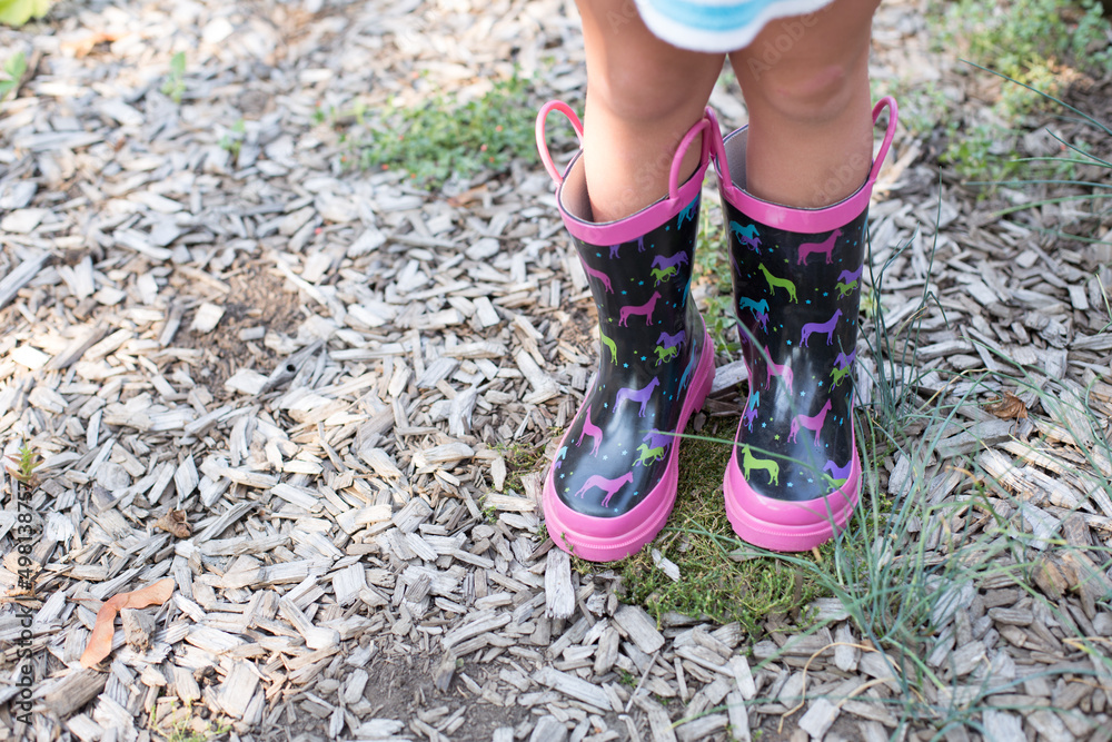 Girl wearing rain boots on sunny day