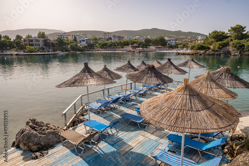 Fototapeta Naklejka Na Ścianę i Meble -  Beautiful beach with umbrellas and sunbeds at Ionian sea in Albania