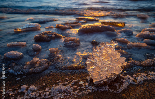 Close-up of piece of ice on snowy beach of Baltic sea at winter. Long exposure.
