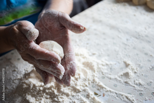 Womans hands rolling the dough for pies. Baking at home