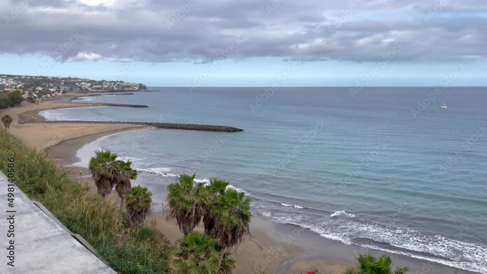 El Aserradero ocean views from Playa del Ingles on cloudy day in Gran Canaria, Spain. San Agustin beach on the background, Canary Islands. Summer vacation, travel destination concept El Aserradero ocean views from Playa del Ingles on cloudy day in Gran Canaria, Spain. San Agustin beach on the background, Canary Islands. Summer vacation, travel destination concept
