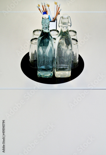 set of glasses and bottles on office desk